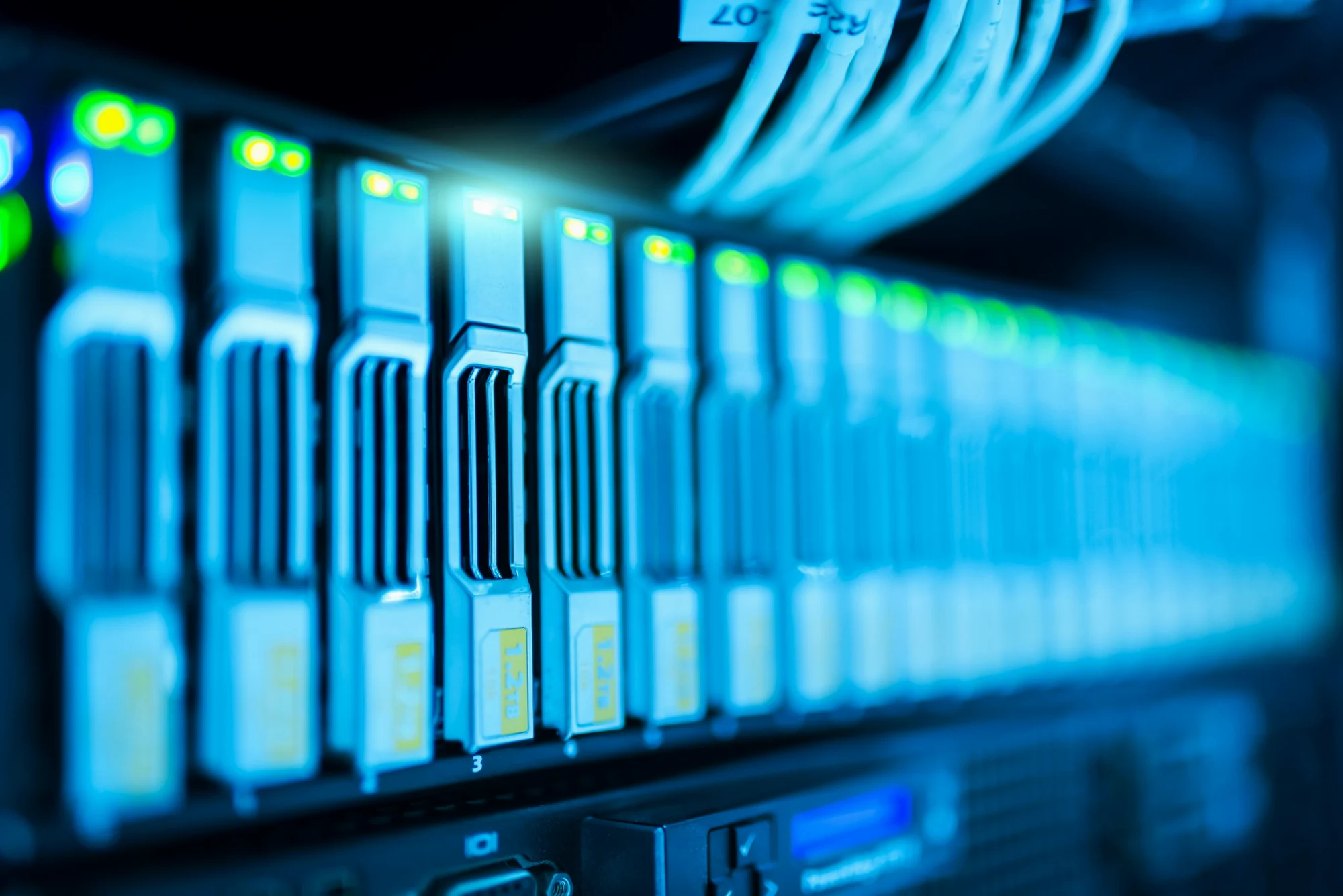 Close-up of business server storage hardware with active drive bays and network cabling